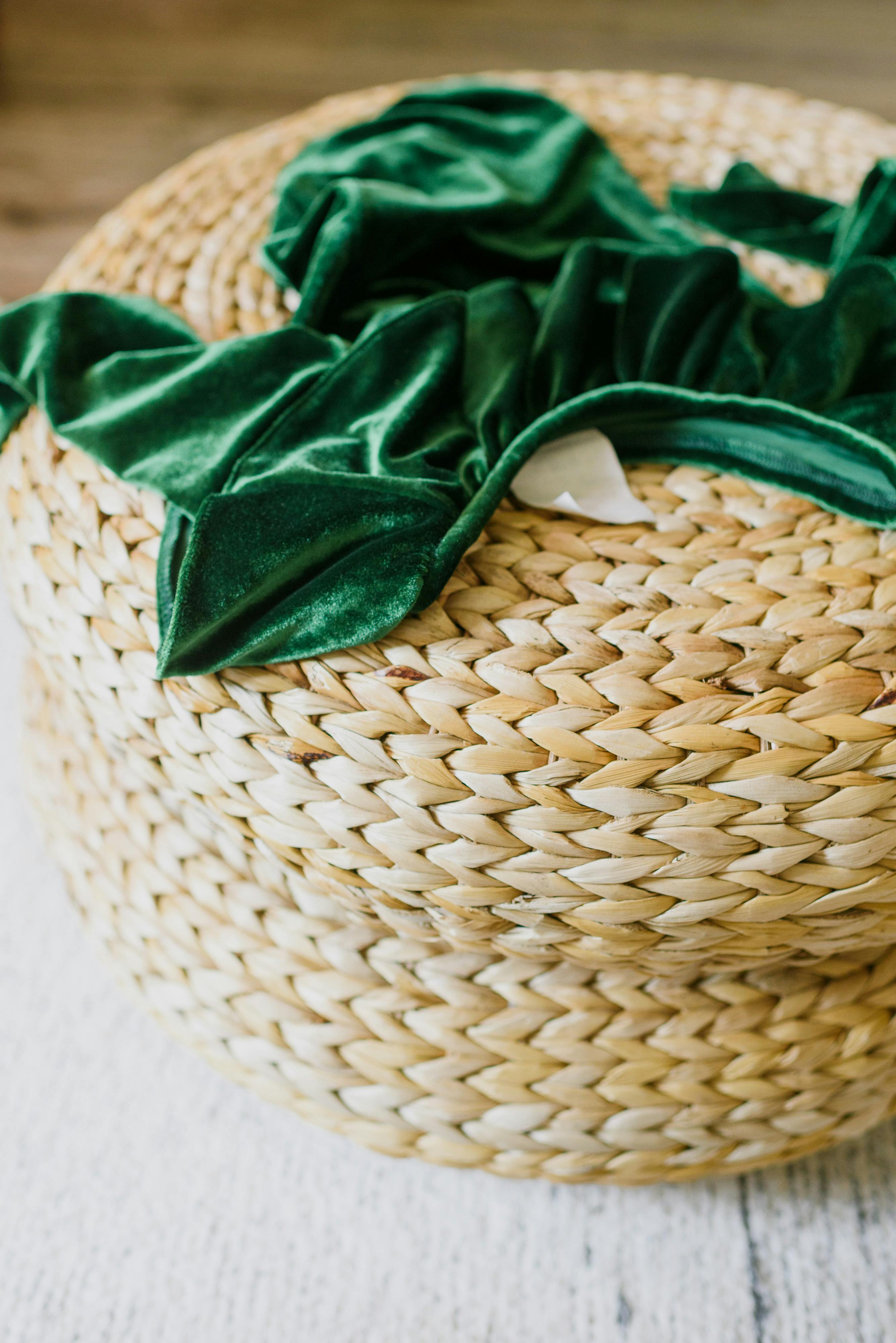 Round woven seagrass storage basket with green throw – eco-conscious natural home décor